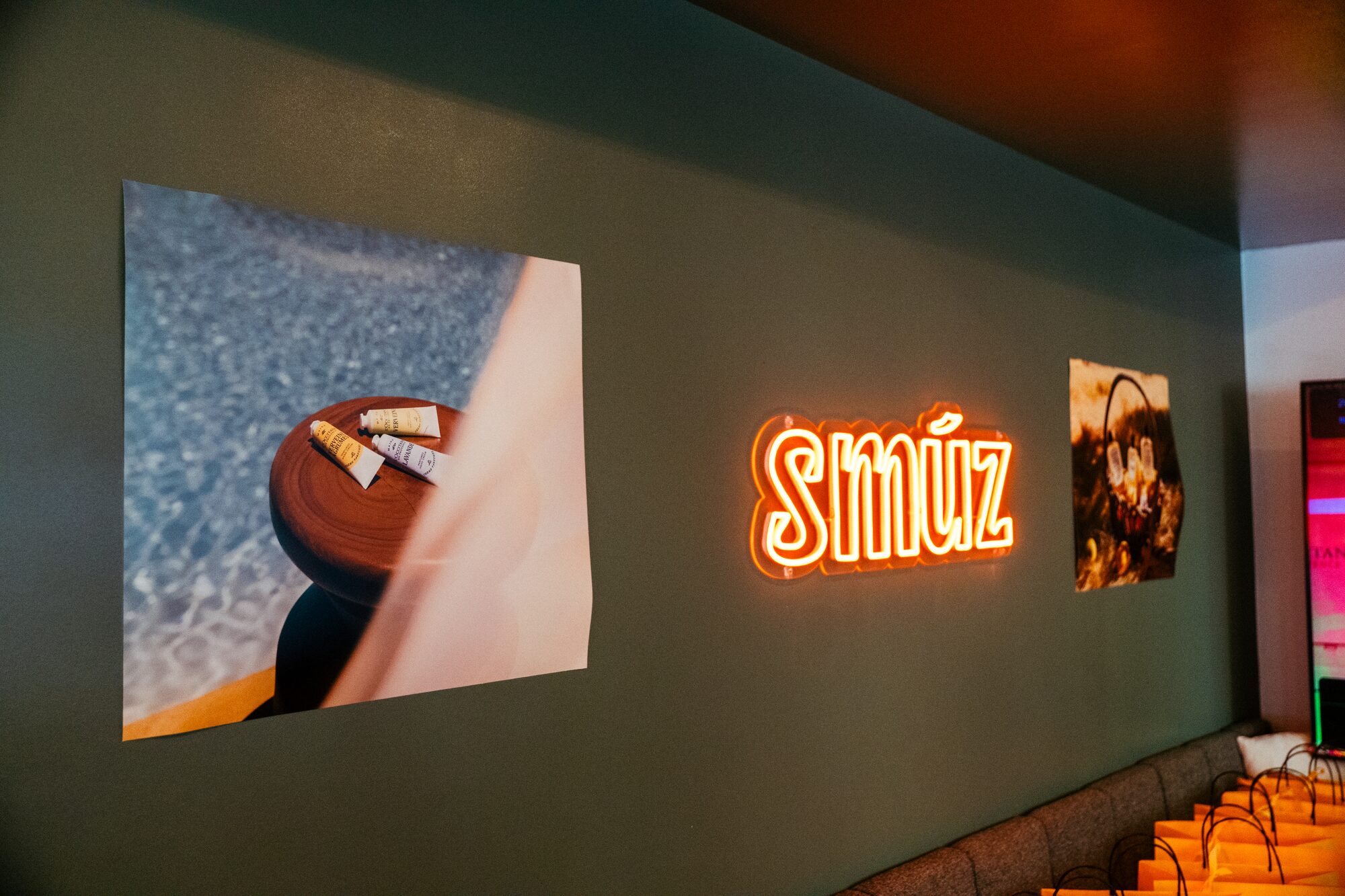 Smúz Café Budapest interior — Smúz neon sign on a green wall, artistic décor