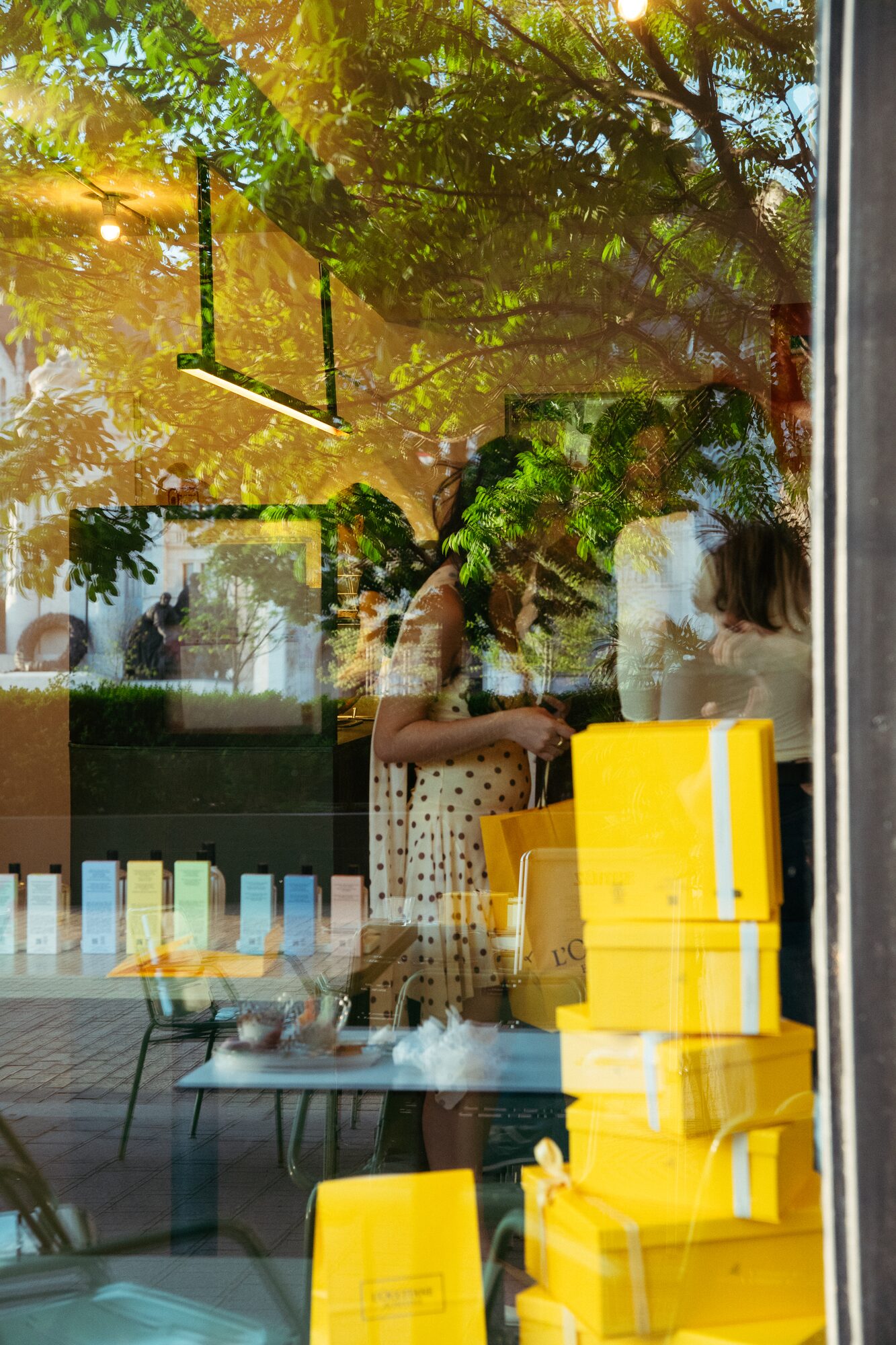 L'Occitane party on the Smúz Café Budapest terrace — artistic reflections with yellow gift boxes